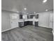 Well-lit kitchen with gray cabinets, stainless steel appliances, and stylish laminate flooring at 3262 Orchard Ave, Indianapolis, IN 46218
