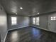 Spacious living room featuring laminate flooring, recessed lighting, and bright, neutral paint at 3262 Orchard Ave, Indianapolis, IN 46218