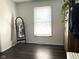 Minimalist bedroom featuring a full-length mirror, bright window, and hardwood floors at 3335 Woodcrest Ct, Columbus, IN 47203