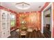 Dining room features a glass table, gold chairs, unique light fixture and a built in cabinet at 3335 Woodcrest Ct, Columbus, IN 47203