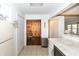 Open kitchen with bar seating, white appliances, and views of the dining and living areas at 3335 Woodcrest Ct, Columbus, IN 47203