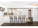 Bright kitchen features bar seating, white cabinetry, and an open layout to living area at 3335 Woodcrest Ct, Columbus, IN 47203