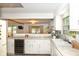 Spacious kitchen featuring white cabinets and an open view of the well-lit living area at 3335 Woodcrest Ct, Columbus, IN 47203