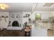 Open living room view to the kitchen with brick fireplace and island with bar stool seating at 3335 Woodcrest Ct, Columbus, IN 47203