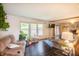 Inviting living room with dark hardwood floors, plush seating, and sunlit windows at 3335 Woodcrest Ct, Columbus, IN 47203