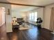 Bright living room featuring hardwood floors, a comfortable couch, and a large window at 3335 Woodcrest Ct, Columbus, IN 47203
