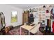 Charming home office with a large window, open shelving, a desk, and a wooden cabinet with storage at 3335 Woodcrest Ct, Columbus, IN 47203