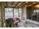 Inviting screened patio with cozy seating, string lights, and views of the outdoors, perfect for relaxation at 3335 Woodcrest Ct, Columbus, IN 47203