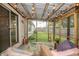 Cozy screened patio with comfortable seating, decorative string lights, and a view of the backyard at 3335 Woodcrest Ct, Columbus, IN 47203