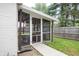 Inviting screened-in patio with charming lights and comfortable seating, perfect for outdoor relaxation and entertaining at 3335 Woodcrest Ct, Columbus, IN 47203