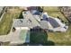 Aerial view of a home with a basketball court, pool, and covered patio area at 4140 Sagewood Ct, Greenwood, IN 46143