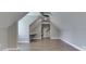 Bright attic space featuring wood floors, a built-in desk, and ample closet space at 4140 Sagewood Ct, Greenwood, IN 46143