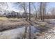 Scenic backyard featuring a flowing stream, a wooden bridge, and lush greenery surrounding the property at 4140 Sagewood Ct, Greenwood, IN 46143