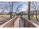Inviting backyard view from a wooden bridge leading to an outdoor patio and a well-maintained lawn at 4140 Sagewood Ct, Greenwood, IN 46143