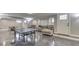 Finished basement with epoxy floors features a ping pong table, seating area, and access to other rooms at 4140 Sagewood Ct, Greenwood, IN 46143