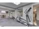 Basement gym equipped with an elliptical machine, bench, mirror and access to other rooms at 4140 Sagewood Ct, Greenwood, IN 46143