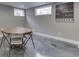 Finished basement featuring an octagonal card table near windows for natural light and ventilation at 4140 Sagewood Ct, Greenwood, IN 46143