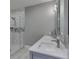 Modern bathroom with a glass shower, gray vanity and marble accents at 4140 Sagewood Ct, Greenwood, IN 46143