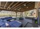 Relaxing covered deck featuring comfortable seating, a fire pit, and a hot tub with backyard views of the neighboring community at 4140 Sagewood Ct, Greenwood, IN 46143