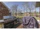 Deck with a stainless steel grill and a view of the backyard, landscaped with mature trees and overlooking neighboring houses at 4140 Sagewood Ct, Greenwood, IN 46143