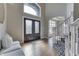 Spacious foyer with wood floors, black stairs, and a double-door entrance at 4140 Sagewood Ct, Greenwood, IN 46143