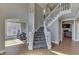 Foyer with a staircase, chandelier, and hardwood floors, offering an inviting entrance at 4140 Sagewood Ct, Greenwood, IN 46143