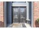 Elegant front door with decorative glass and a gray exterior with brick accents at 4140 Sagewood Ct, Greenwood, IN 46143
