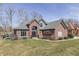 Beautiful brick home featuring an arched entryway and manicured front lawn at 4140 Sagewood Ct, Greenwood, IN 46143