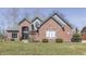 Attractive brick home featuring a well-maintained lawn and manicured shrubs at 4140 Sagewood Ct, Greenwood, IN 46143