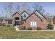Charming front exterior of a brick home with a manicured lawn, showcasing curb appeal and elegance at 4140 Sagewood Ct, Greenwood, IN 46143