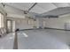 Spacious garage with epoxy flooring, storage cabinets, and ample room for vehicles and projects at 4140 Sagewood Ct, Greenwood, IN 46143