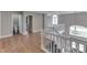 Hallway features wood floors, white railing, and natural light at 4140 Sagewood Ct, Greenwood, IN 46143