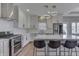A well-lit kitchen offers stainless steel appliances, white backsplash and countertops and natural hardwood floors at 4140 Sagewood Ct, Greenwood, IN 46143