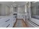 Bright kitchen with stainless steel appliances, white cabinets, large center island and gray flooring at 4140 Sagewood Ct, Greenwood, IN 46143