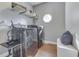 Laundry room featuring high-end washer and dryer set, hardwood floors, and custom shelving for ample storage at 4140 Sagewood Ct, Greenwood, IN 46143
