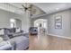 Open living room featuring high ceilings, hardwood floors, and a gray sectional sofa at 4140 Sagewood Ct, Greenwood, IN 46143