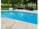 An in-ground pool surrounded by a concrete deck and black metal fence at 4140 Sagewood Ct, Greenwood, IN 46143