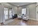 Cozy sitting area features hardwood floors, two neutral armchairs, and curtains at 4140 Sagewood Ct, Greenwood, IN 46143