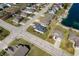 Expansive aerial view of a residential area with neatly maintained lawns and a pond with a sandy beach at 4347 Westminster Pl, Columbus, IN 47201