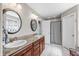 Contemporary bathroom featuring double sinks with granite counters and tiled floors at 4347 Westminster Pl, Columbus, IN 47201