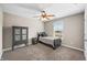 Bedroom with neutral walls, ceiling fan, carpet and black furniture at 4347 Westminster Pl, Columbus, IN 47201