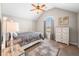 Vaulted ceiling bedroom features a ceiling fan, carpet, area rug, and a window at 4347 Westminster Pl, Columbus, IN 47201
