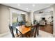 Inviting dining room with a wooden table, black chairs, and a view to the backyard through a sliding glass door at 4347 Westminster Pl, Columbus, IN 47201