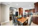 Bright dining area with a wooden table, black chairs, and an archway leading to the living room and kitchen at 4347 Westminster Pl, Columbus, IN 47201