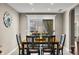 Cozy dining room with a wooden table, black chairs, and a decorative clock on the wall near the window at 4347 Westminster Pl, Columbus, IN 47201
