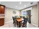 Charming dining room with a wooden table, black chairs, and a sliding door to the outside at 4347 Westminster Pl, Columbus, IN 47201