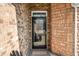 Close-up of a glass-paneled front door with decorative brickwork and a welcome mat at 4347 Westminster Pl, Columbus, IN 47201