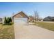 Well-kept home with brick accents, a wide driveway, and green lawn at 4347 Westminster Pl, Columbus, IN 47201
