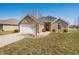 Charming single-story home featuring a brick exterior, attached garage, and well-maintained lawn at 4347 Westminster Pl, Columbus, IN 47201