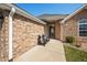 Inviting porch with brick siding, seating, and well-kept landscaping at 4347 Westminster Pl, Columbus, IN 47201